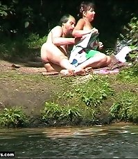 Nudists filmed as they make out on a beach