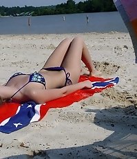 Charming girls relaxing on the beach in sexy bikinis