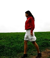 Barely legal brunette tinkling alone on a field