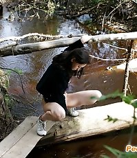 Spy busts a hot young chick pissing into the river